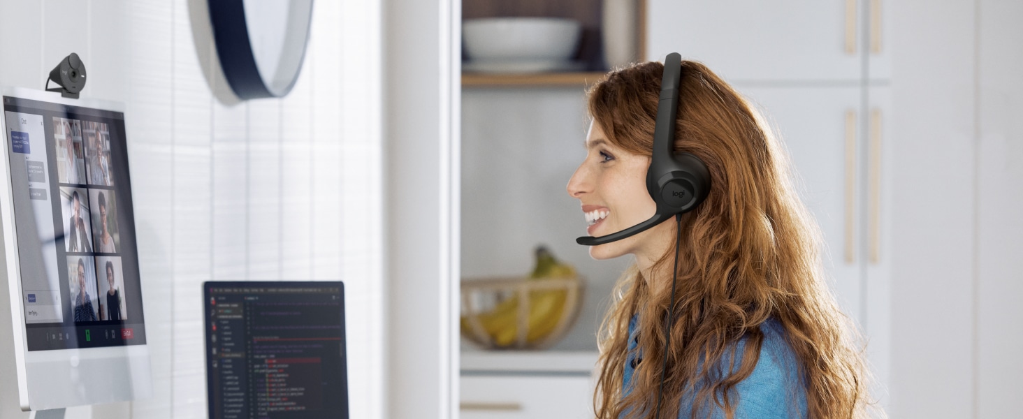 a woman having a video call using h390 wired stereo black headset with noise-cancelling microphone