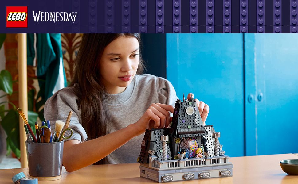 Girl building Wednesday Addams toy house 